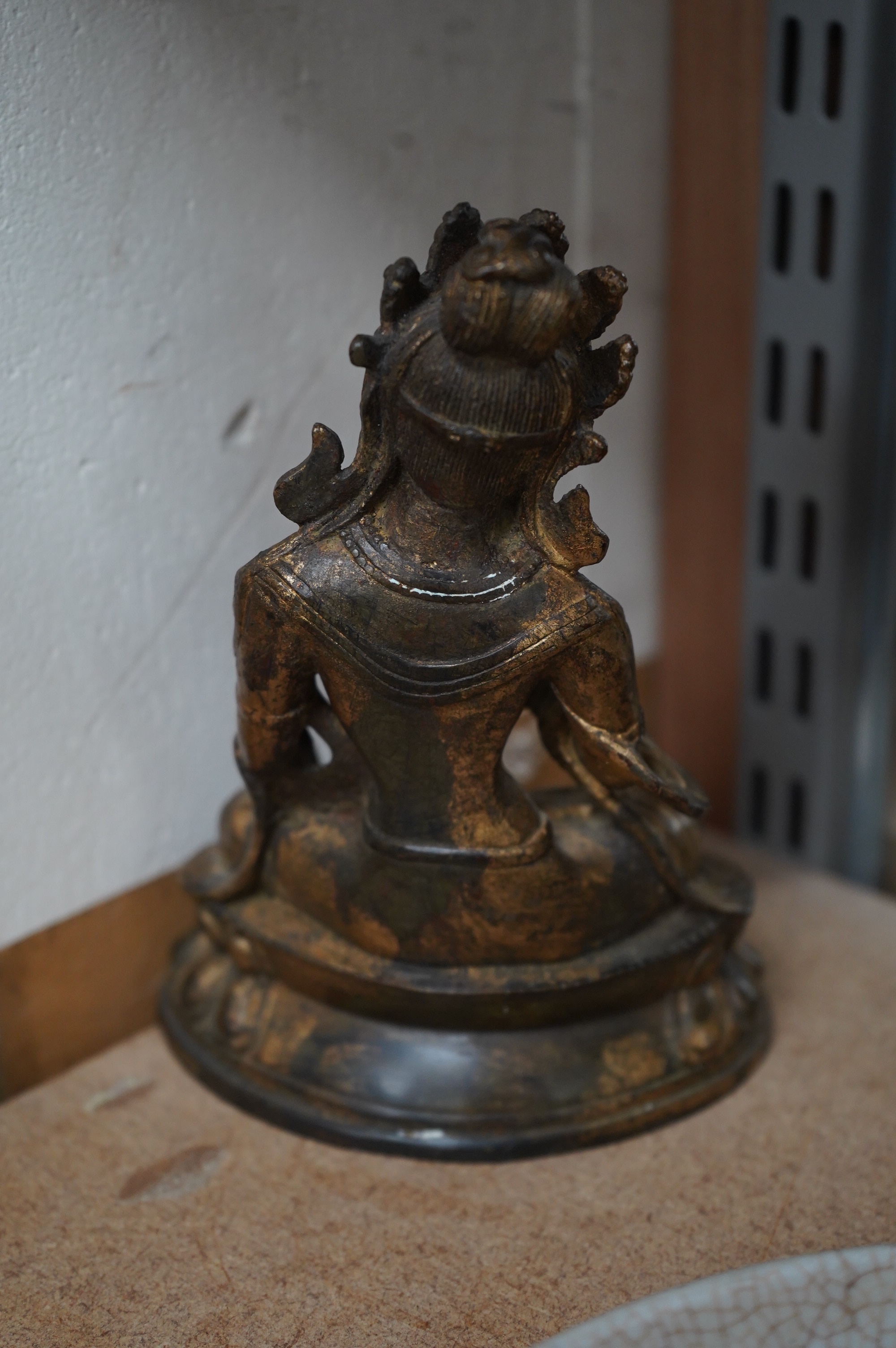 A Tibetan gilt bronze figure of seated Tara, on a double lotus throne, 16.5cm high. Condition - good